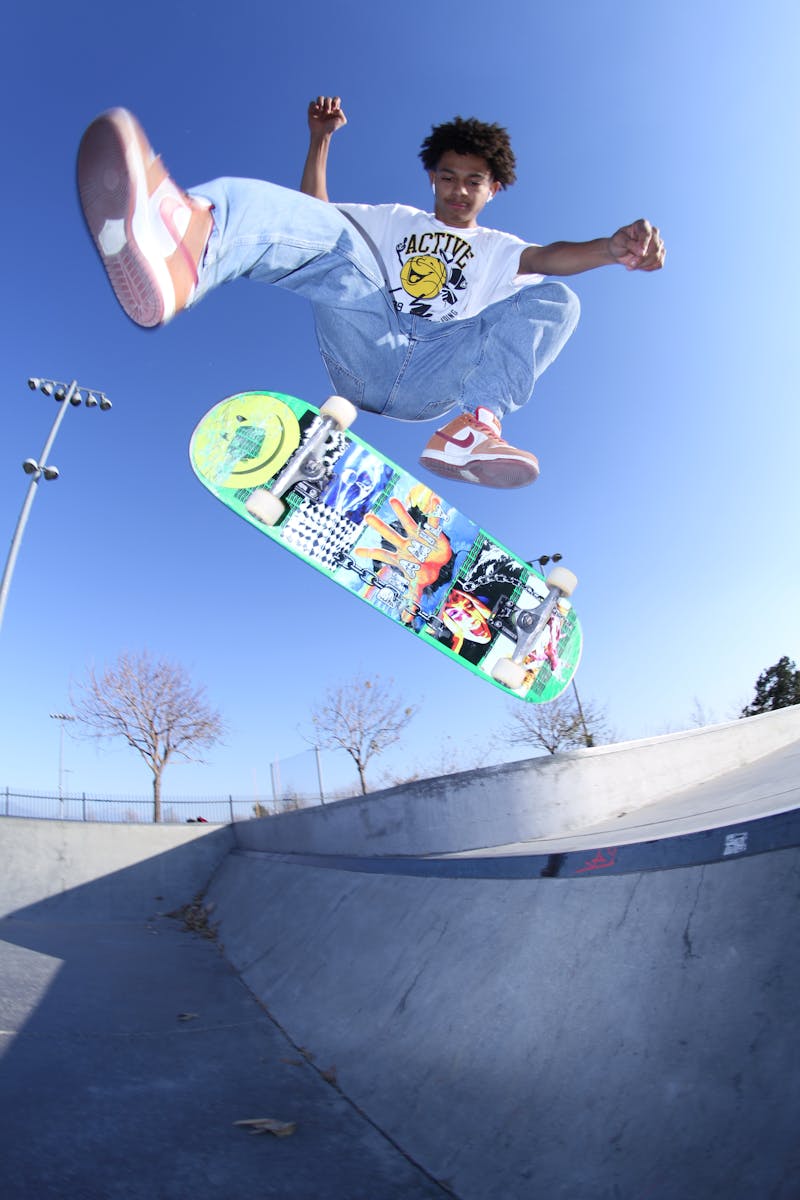 Skateboarder performing a kickflip at a skatepark