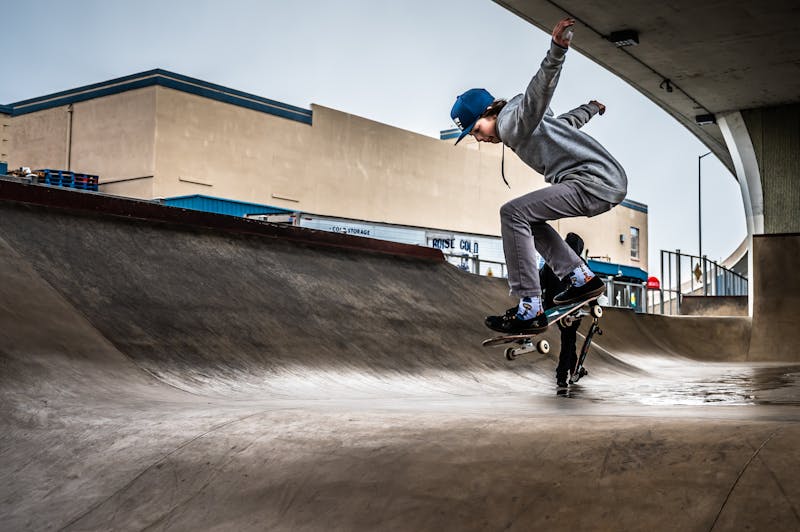 Skateboarder performing a trick inside a covered skatepark
