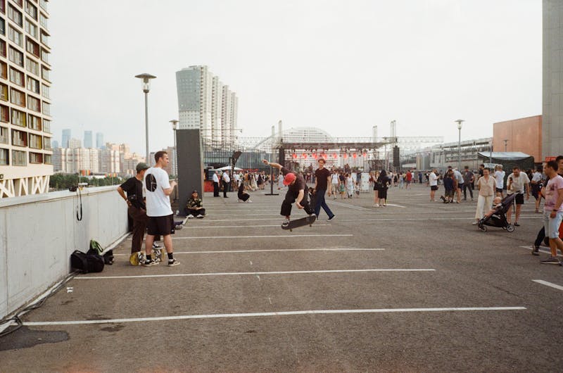 Urban plaza with skaters and city skyline