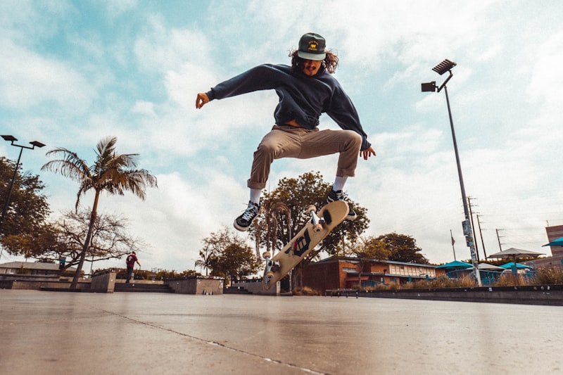Skateboarder performing a flatground trick on smooth pavement