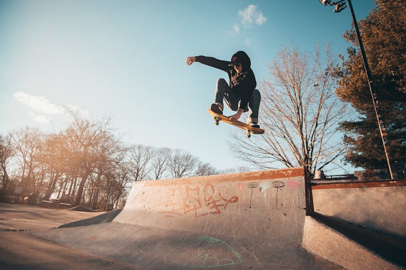 Skateboarder doing a grab trick off a ramp